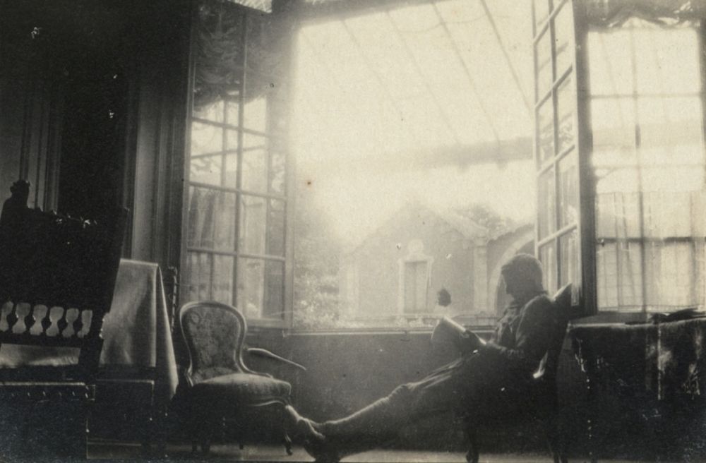 Lieutenant Kenneth Cameron Clayton of the New Zealand Rifle Brigade relaxes in his billet at Armentières, Belgium.